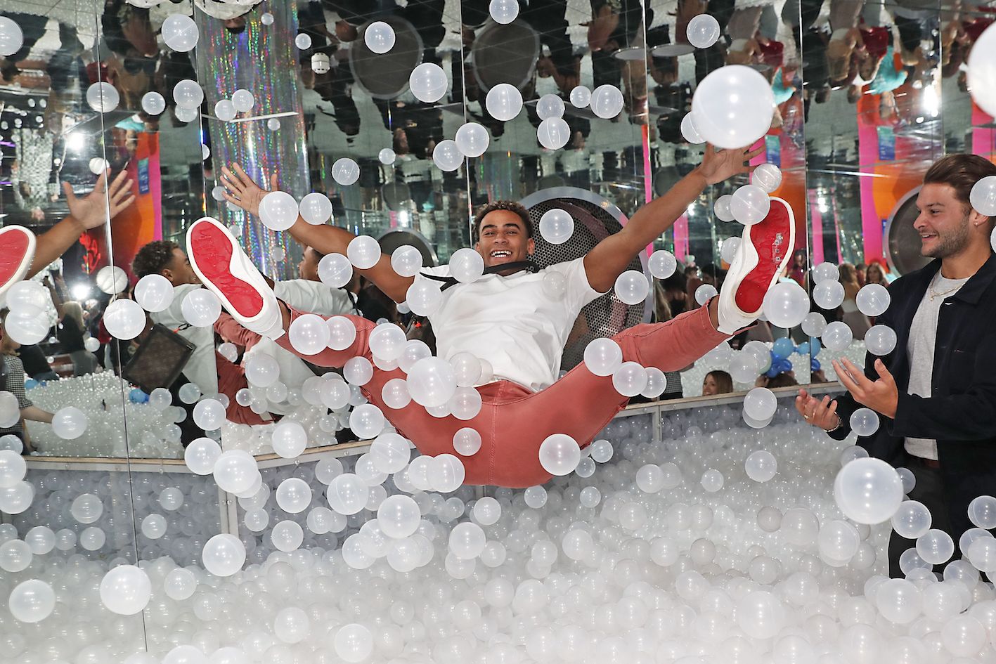 man jumping into ball pit