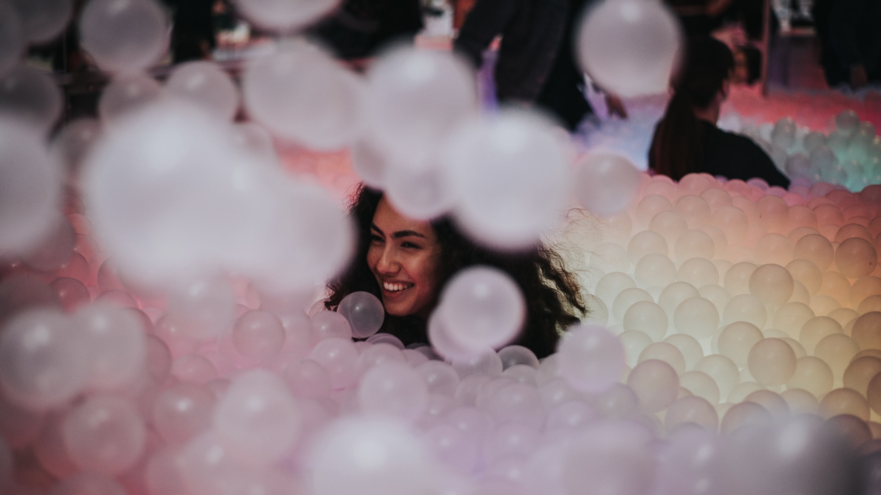 a happy woman in a ball pit