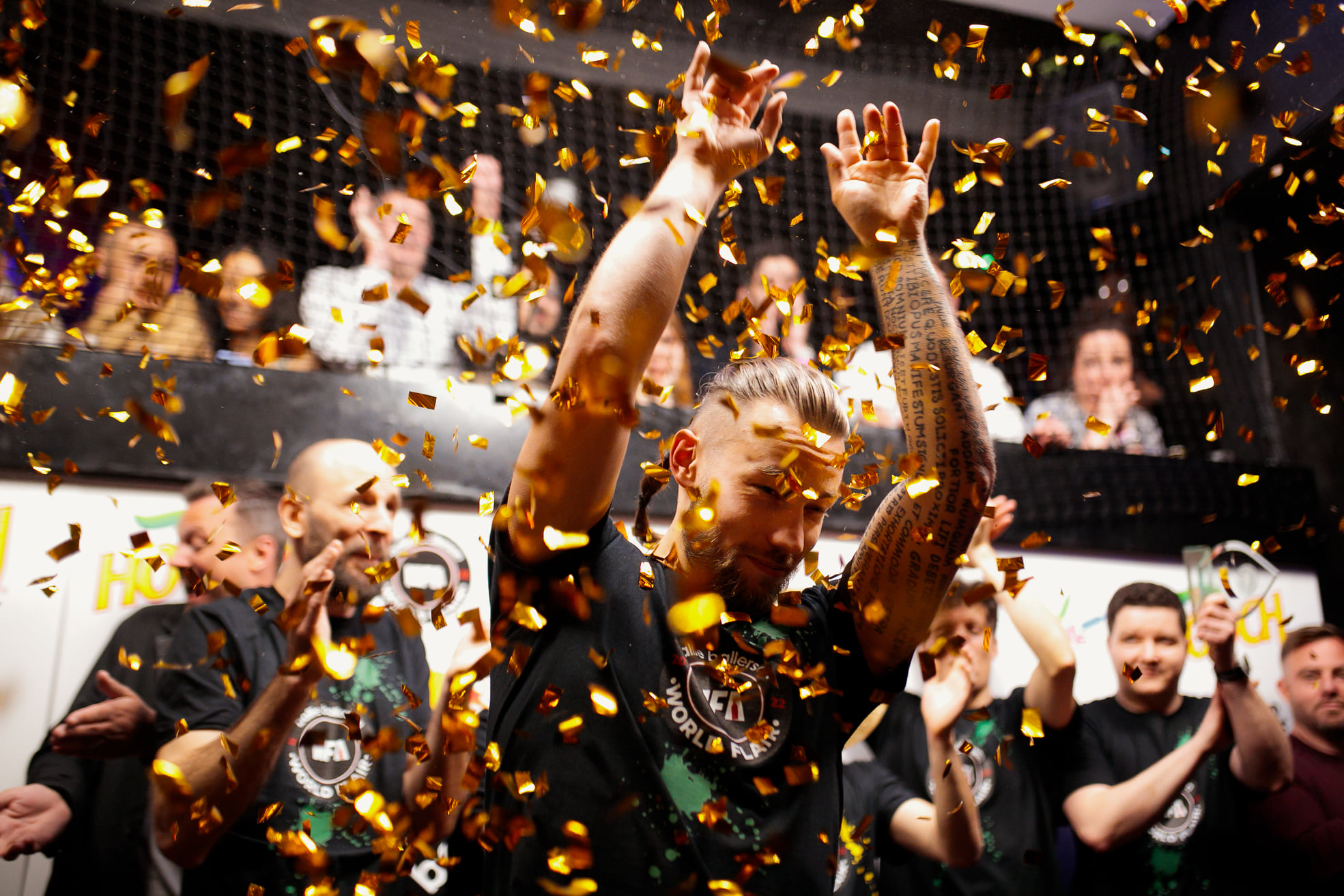 man celebrating under confetti cannons