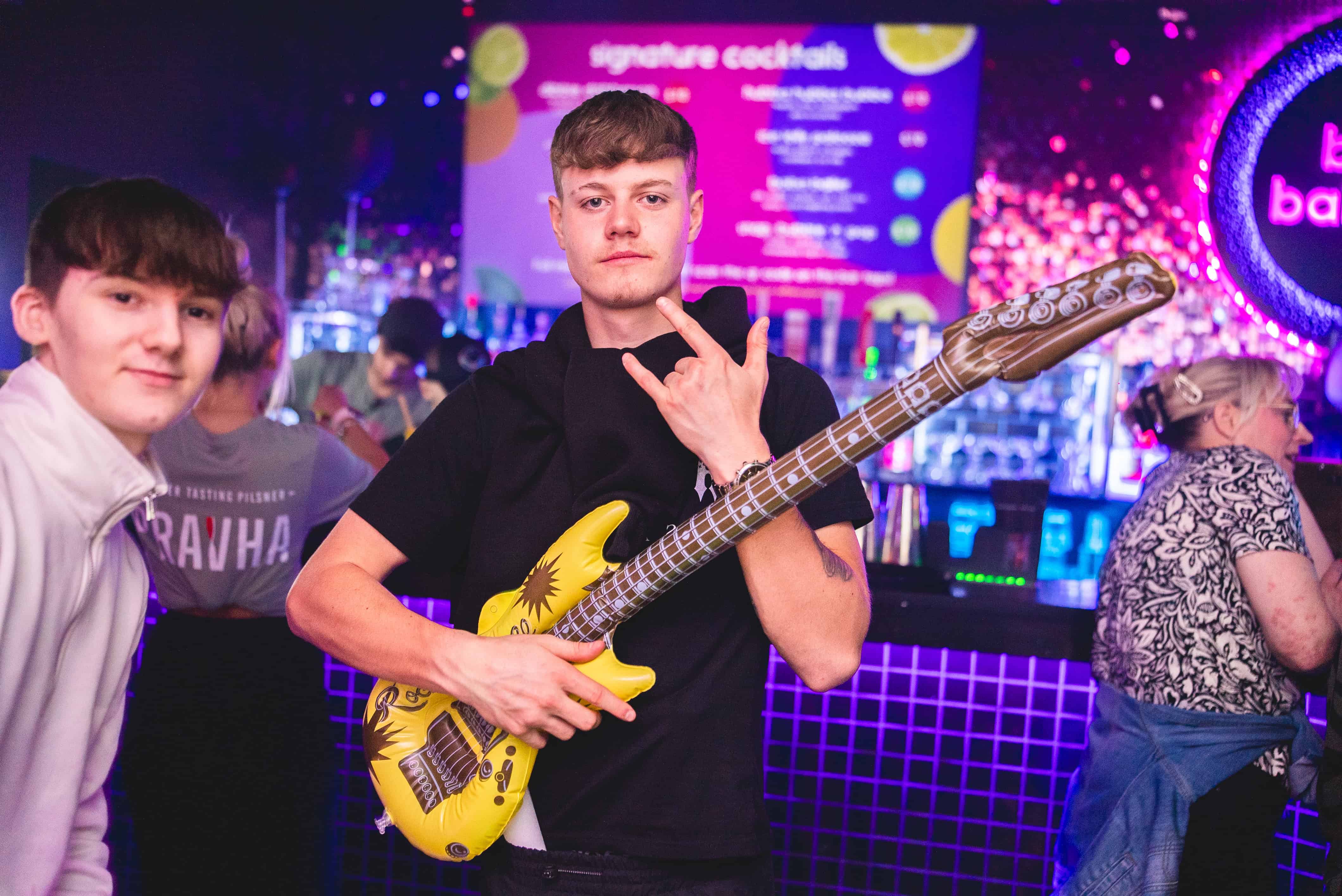 a group of friends eating pizza and drinking prosecco taking a selfie