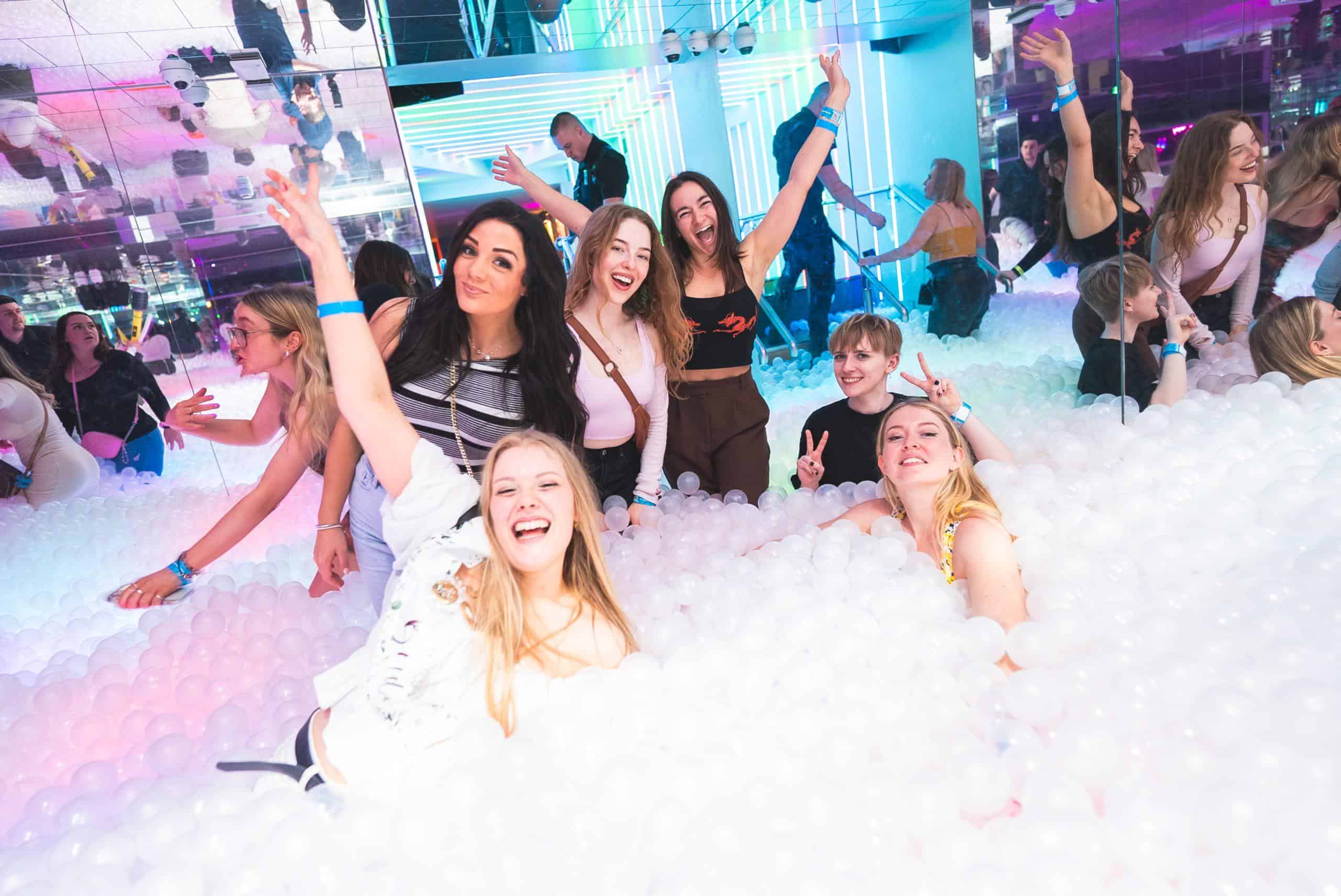 Colourful bar with neon sign at Ballie Ballerson; vibrant nightlife, cocktails and fun atmosphere.
