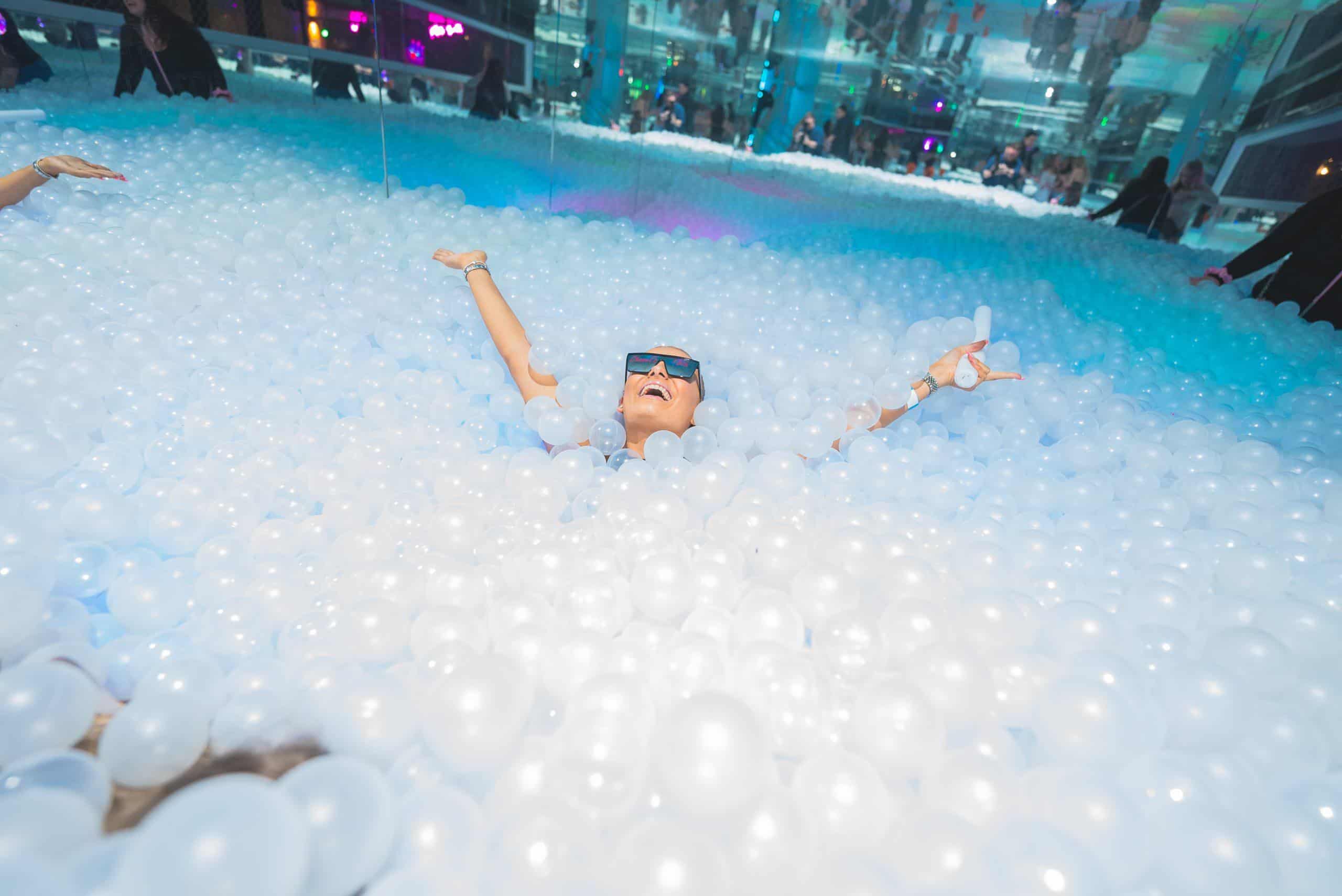 Vibrant ball pit with colourful LED lighting at Ballie Ballerson, a popular London nightlife and entertainment venue.