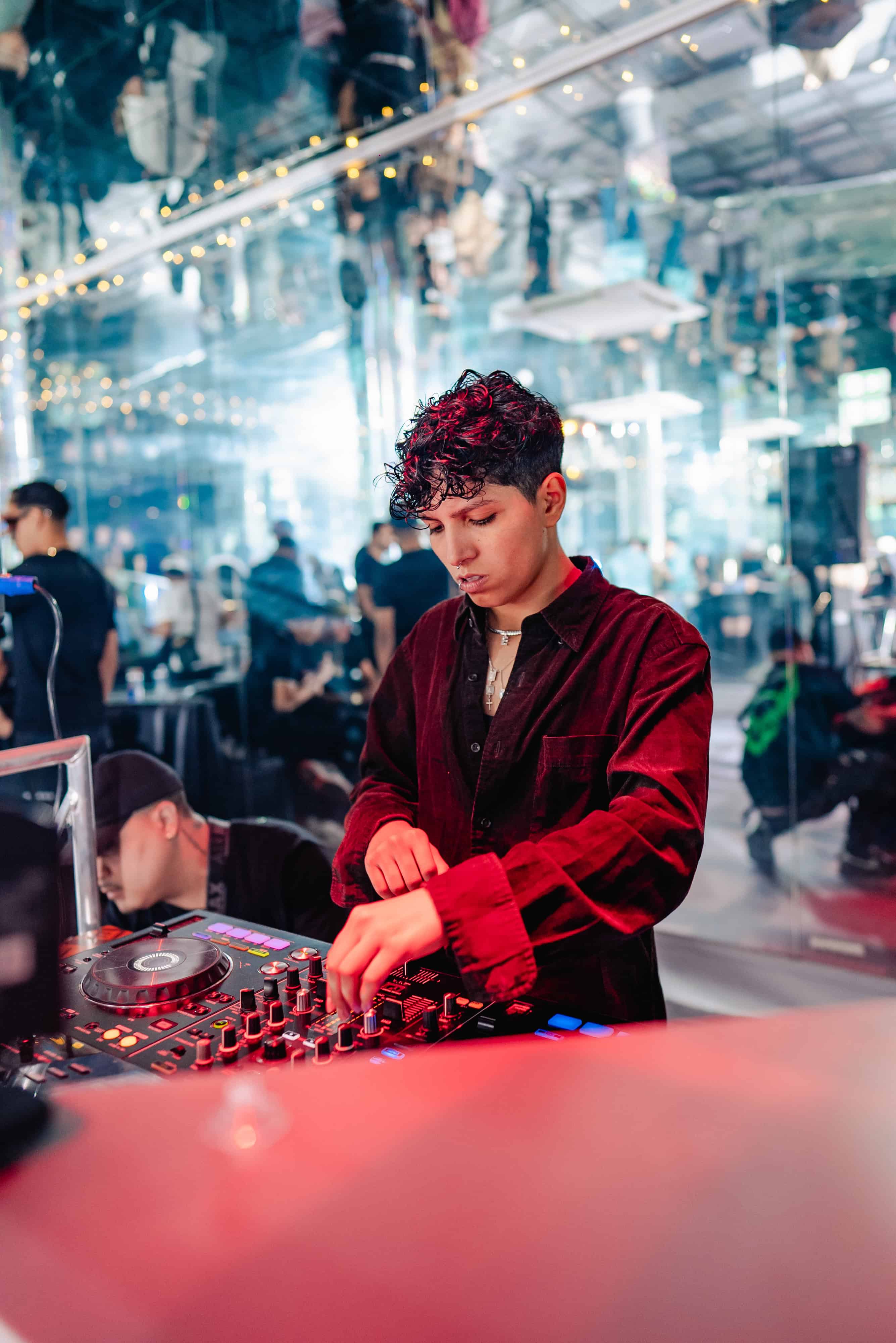 a group of friends drinking prosecco, one man is holding a birthday cake with sparklers sticking out of the top