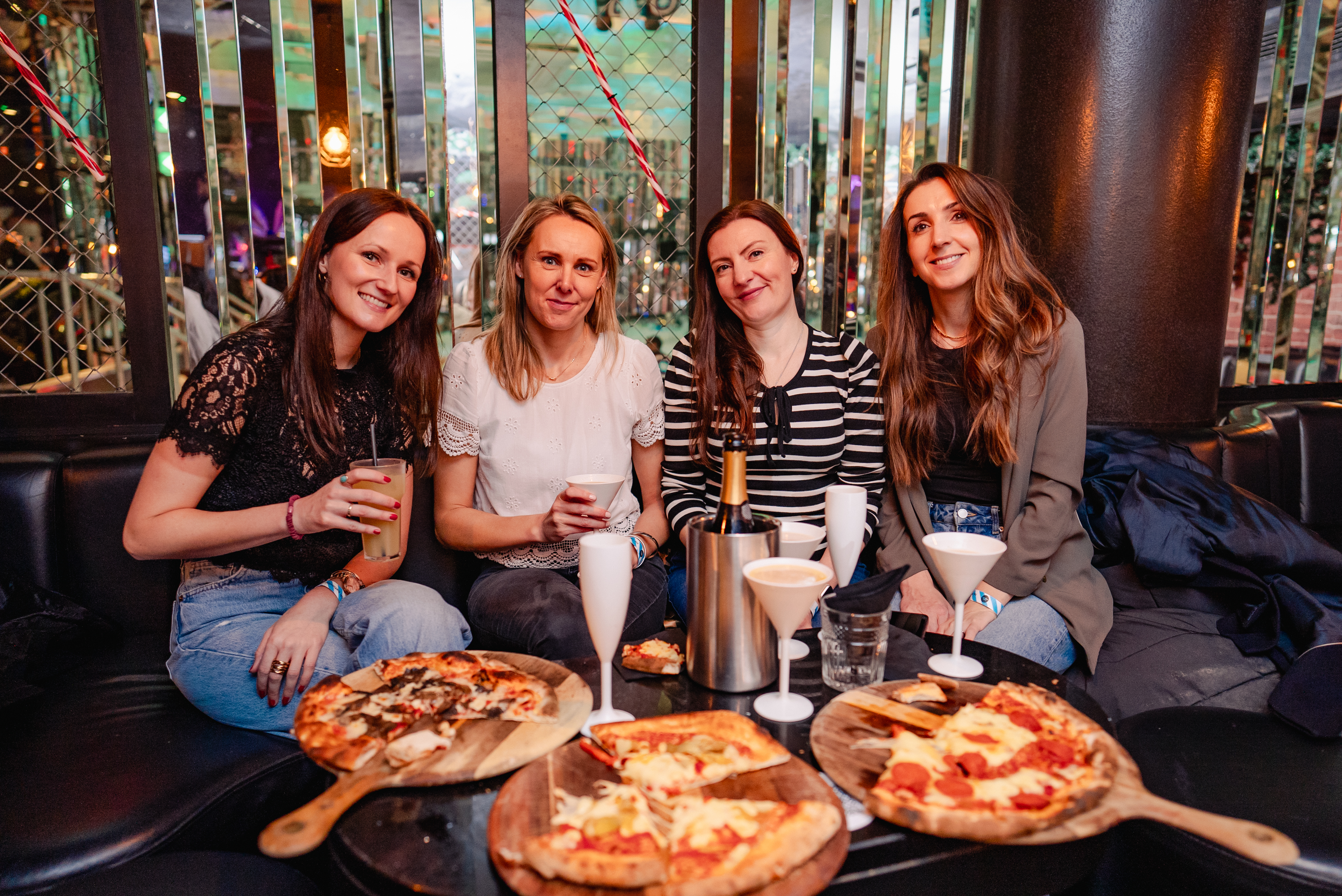 a group of friends eating pizza and drinking prosecco taking a selfie