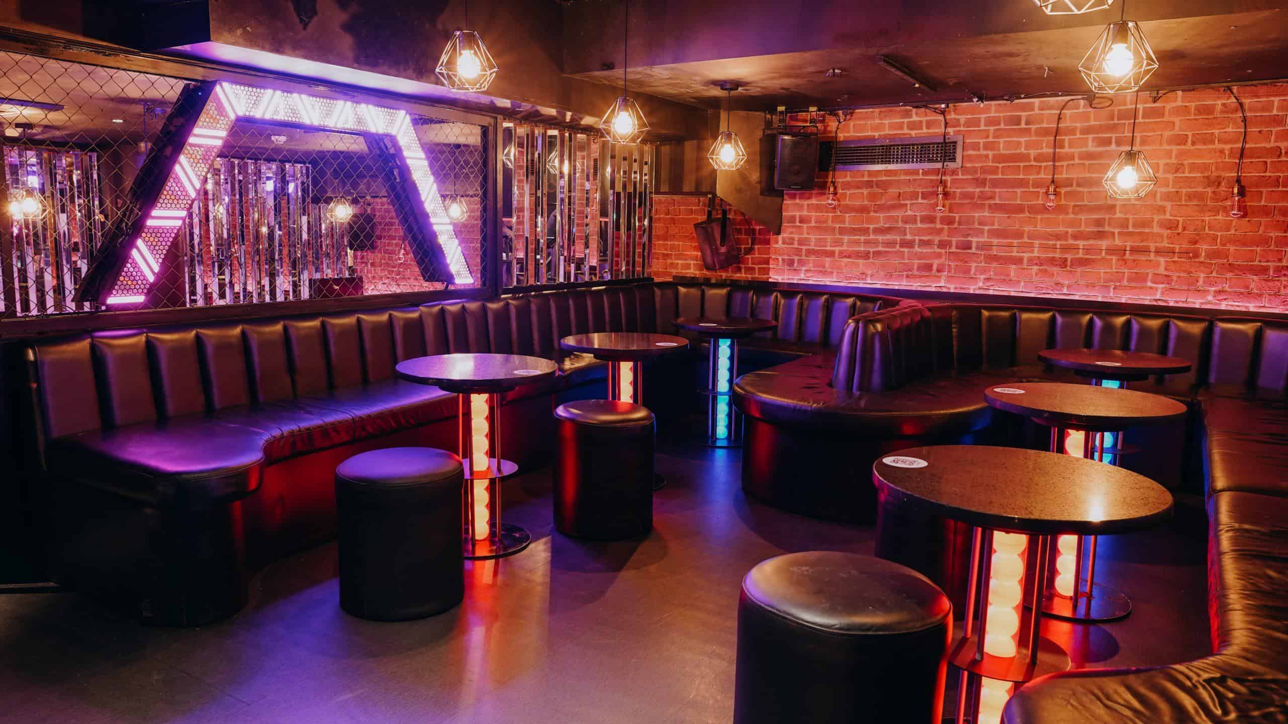 Colourful ball pit area with neon lighting at a party venue, vibrant and playful atmosphere.