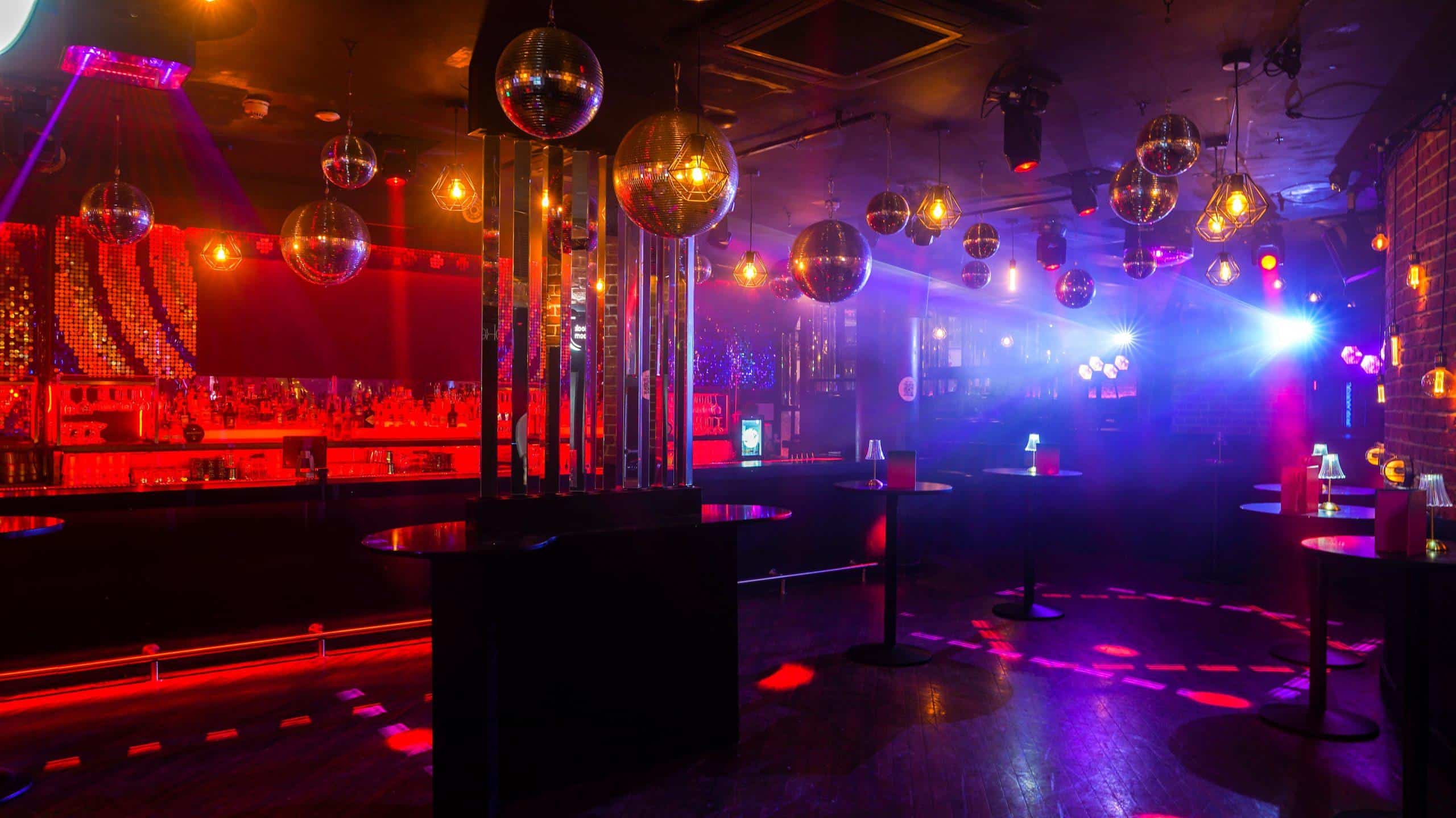 Vibrant illuminated interior of Ballie Ballerson, a popular adult nightclub and cocktail bar with colourful lighting.