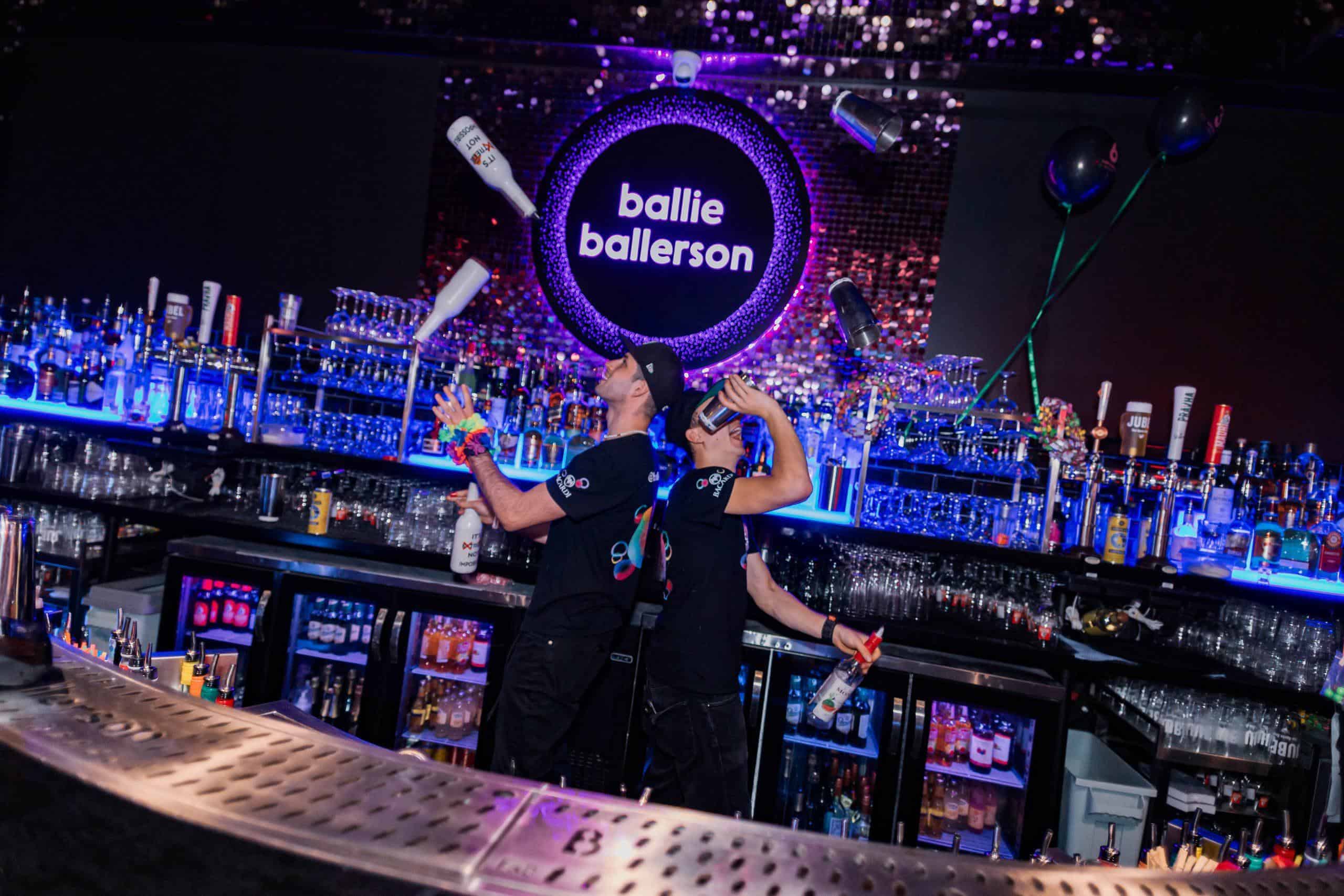 Colourful bar with neon sign at Ballie Ballerson; vibrant nightlife, cocktails and fun atmosphere.