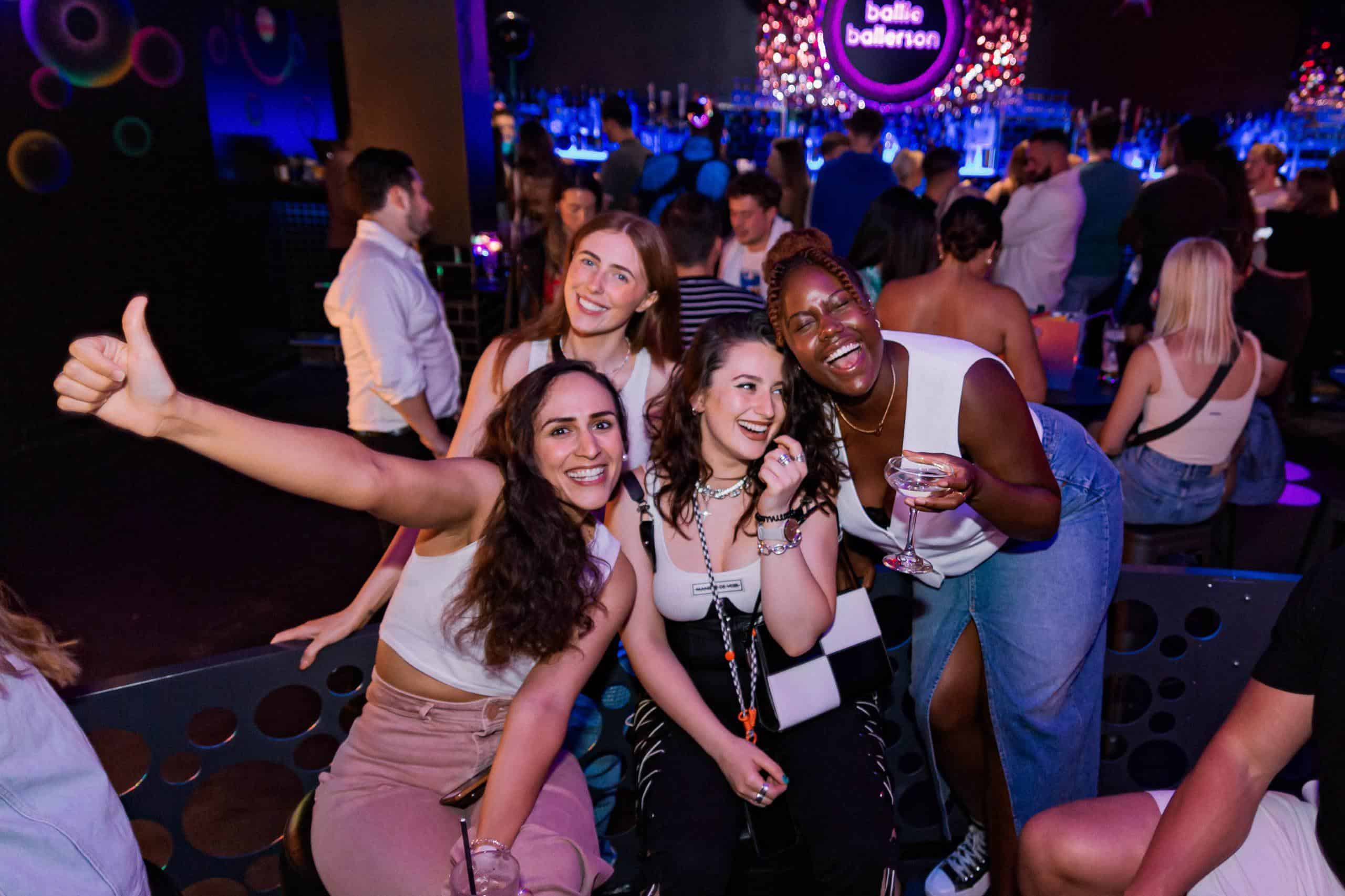 Vibrant scene at Ballie Ballerson with friends enjoying a lively night in the famous London ball pit bar.