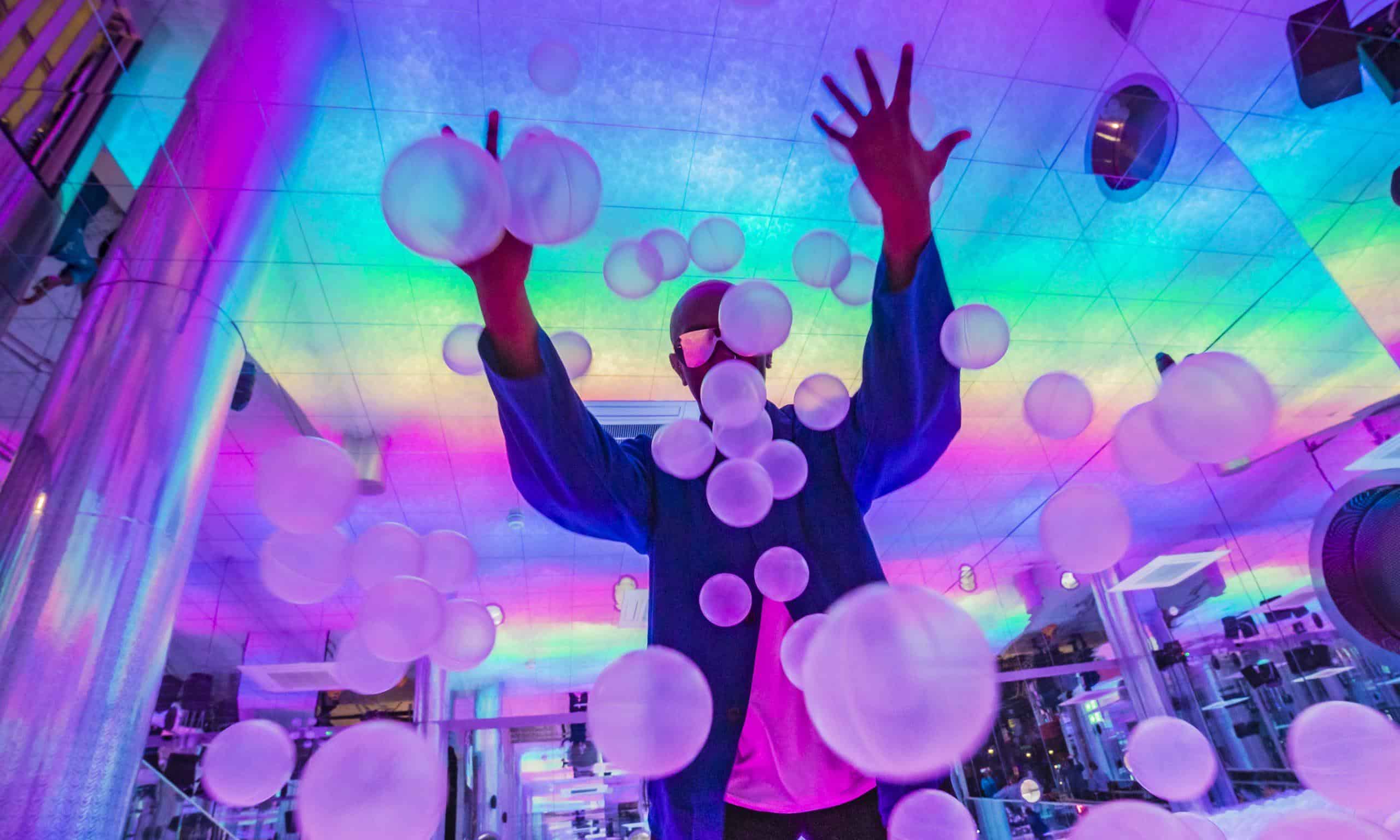 Colourful ball pit with vibrant lighting and playful atmosphere at Ballie Ballerson, a popular adult entertainment venue in London.