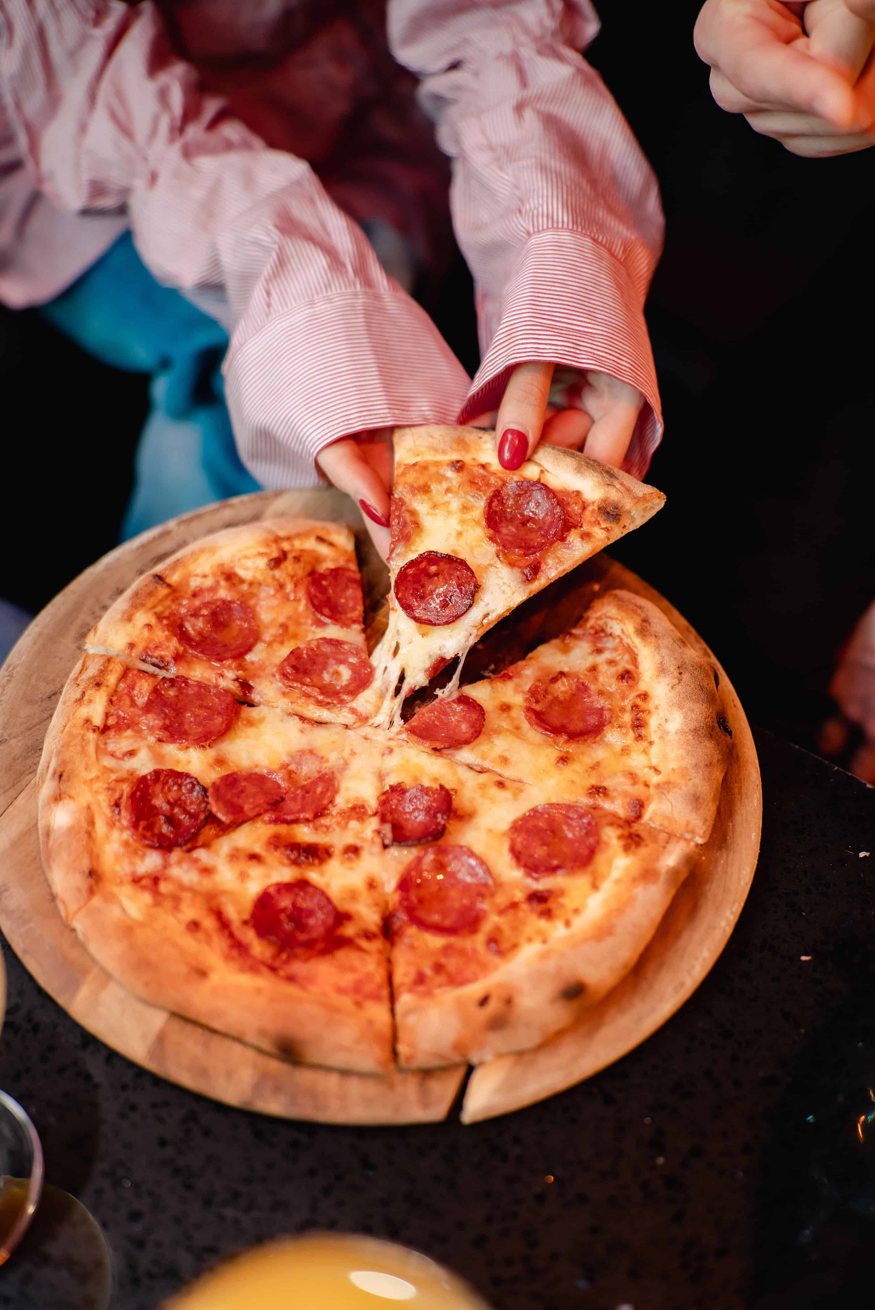Cream Pizza with Pepperoni on Wooden Board at Ballie Ballerson.